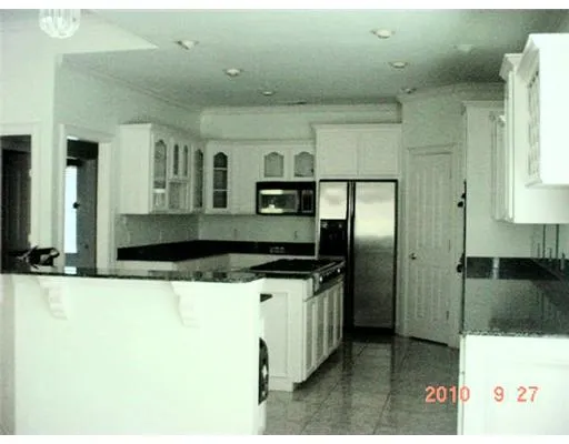 a kitchen with stainless steel appliances kitchen island a refrigerator sink and stove