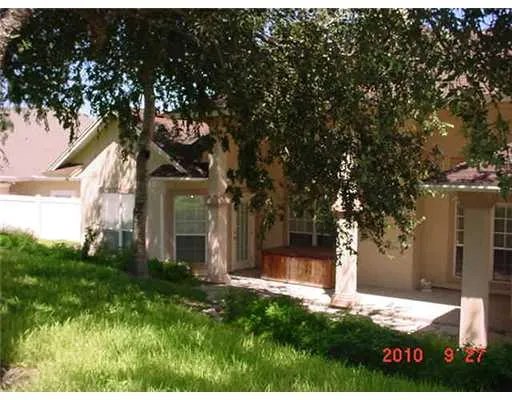 a view of a house with a tree in a yard