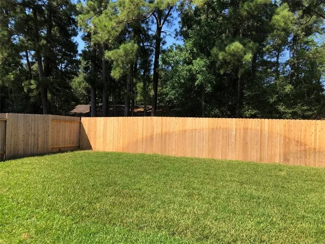 a view of yard with trees in the background