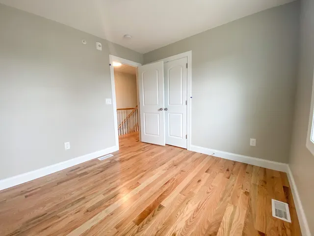 a view of an empty room and wooden floor
