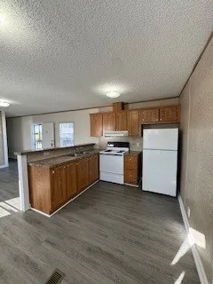 a view of kitchen with wooden floor
