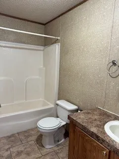 a bathroom with a granite countertop bathtub shower sink