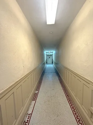 a view of hallway with wooden floor