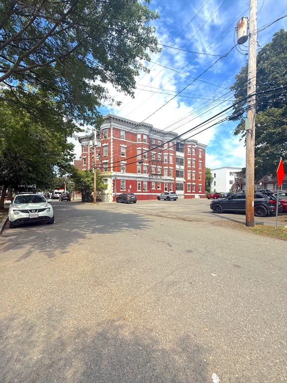 20 Huss Court, Unit 105 Lynn, MA 01905 - Photo 2 of 16 a view of street with parked cars