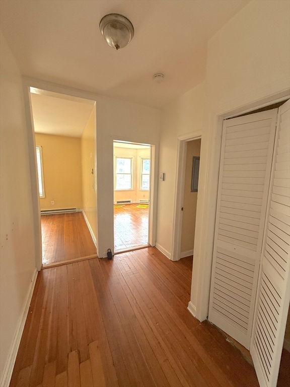 20 Huss Court, Unit 105 Lynn, MA 01905 - Photo 7 of 16 wooden floor in an empty room with a window