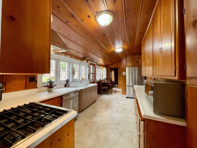 a large kitchen with stainless steel appliances granite countertop a stove and a refrigerator