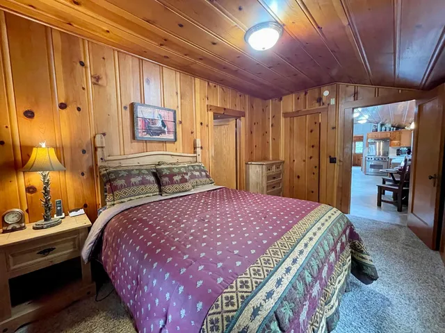 a bedroom with a bed and a mirror