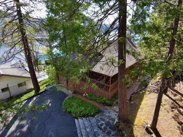 a view of a house with wooden deck front of house