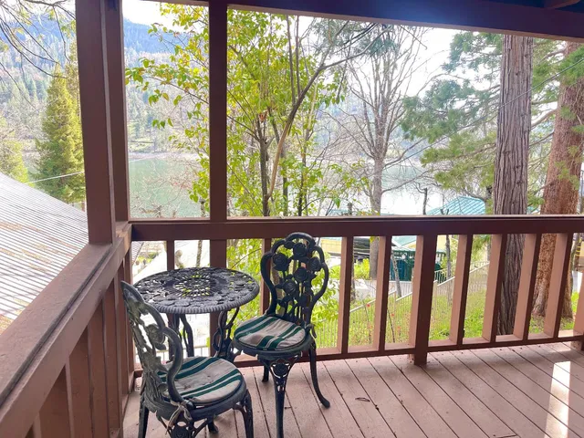 a view of a wooden chairs on the roof deck
