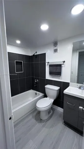 a bathroom with a toilet a sink and bathtub