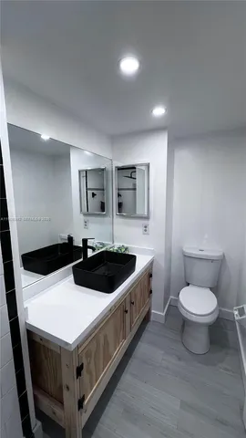 a kitchen with a sink and a toilet
