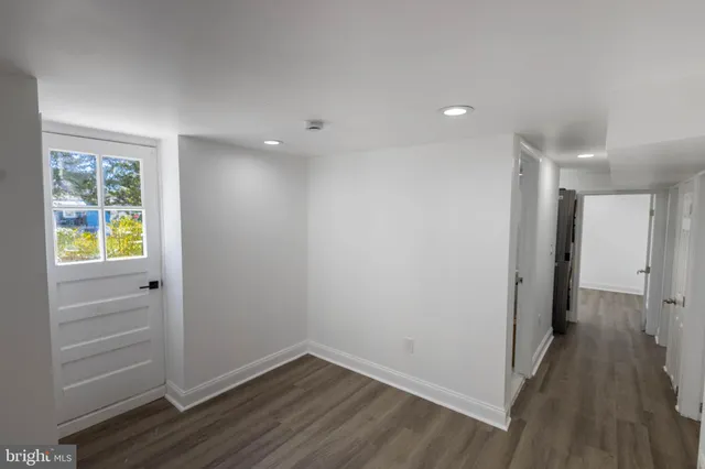 a view of hallway with wooden floor