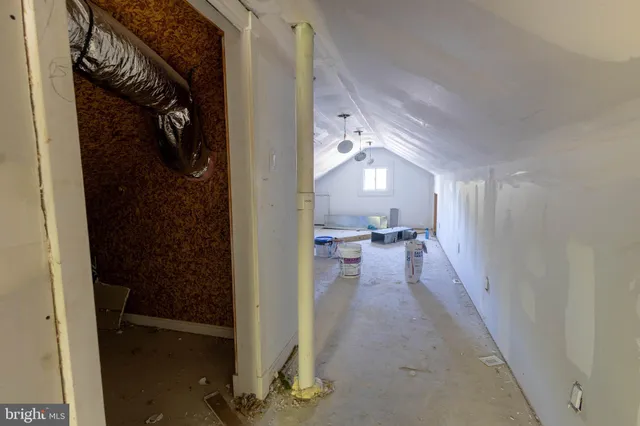 a view of a hallway and a livingroom with furniture