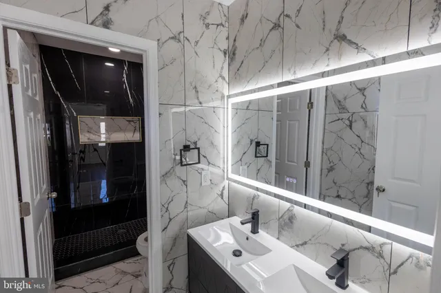 a bathroom with a sink and mirror
