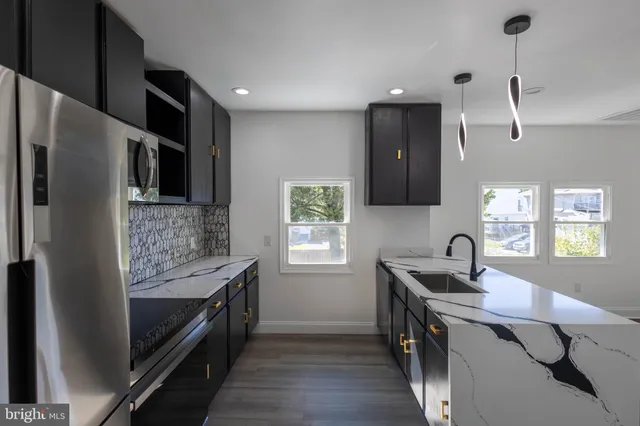 a kitchen with a sink stove and refrigerator