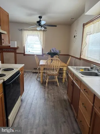 a kitchen with a wooden floor and a stove top oven