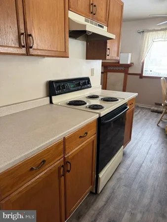 a stove top oven sitting inside of a kitchen