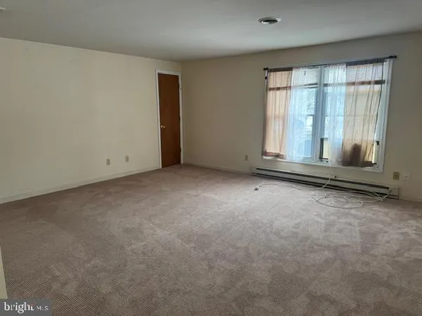 an empty room with large windows