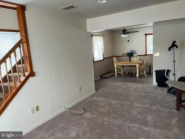 a view of a livingroom with furniture and a window