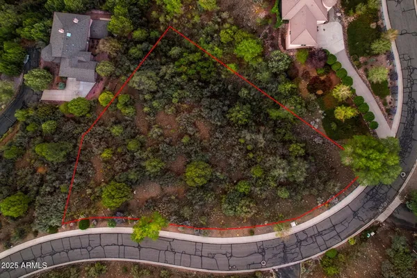 an aerial view of a house with a yard basket ball court and outdoor seating