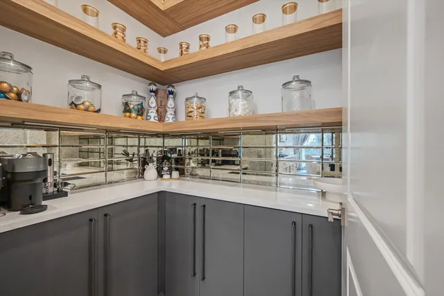 a view of a kitchen with stainless steel appliances a sink and a stove