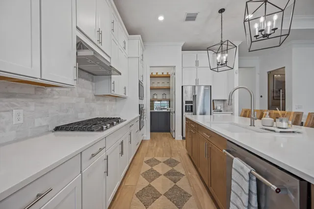 a kitchen with stainless steel appliances granite countertop a sink and stove