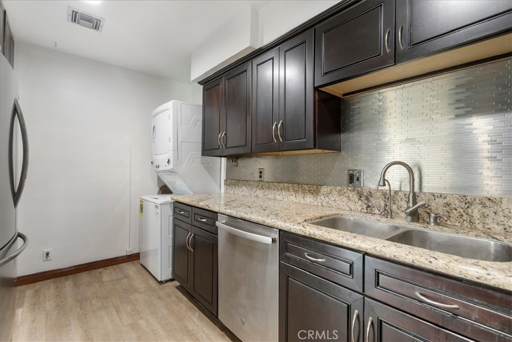 a kitchen with stainless steel appliances granite countertop a sink stove and cabinets