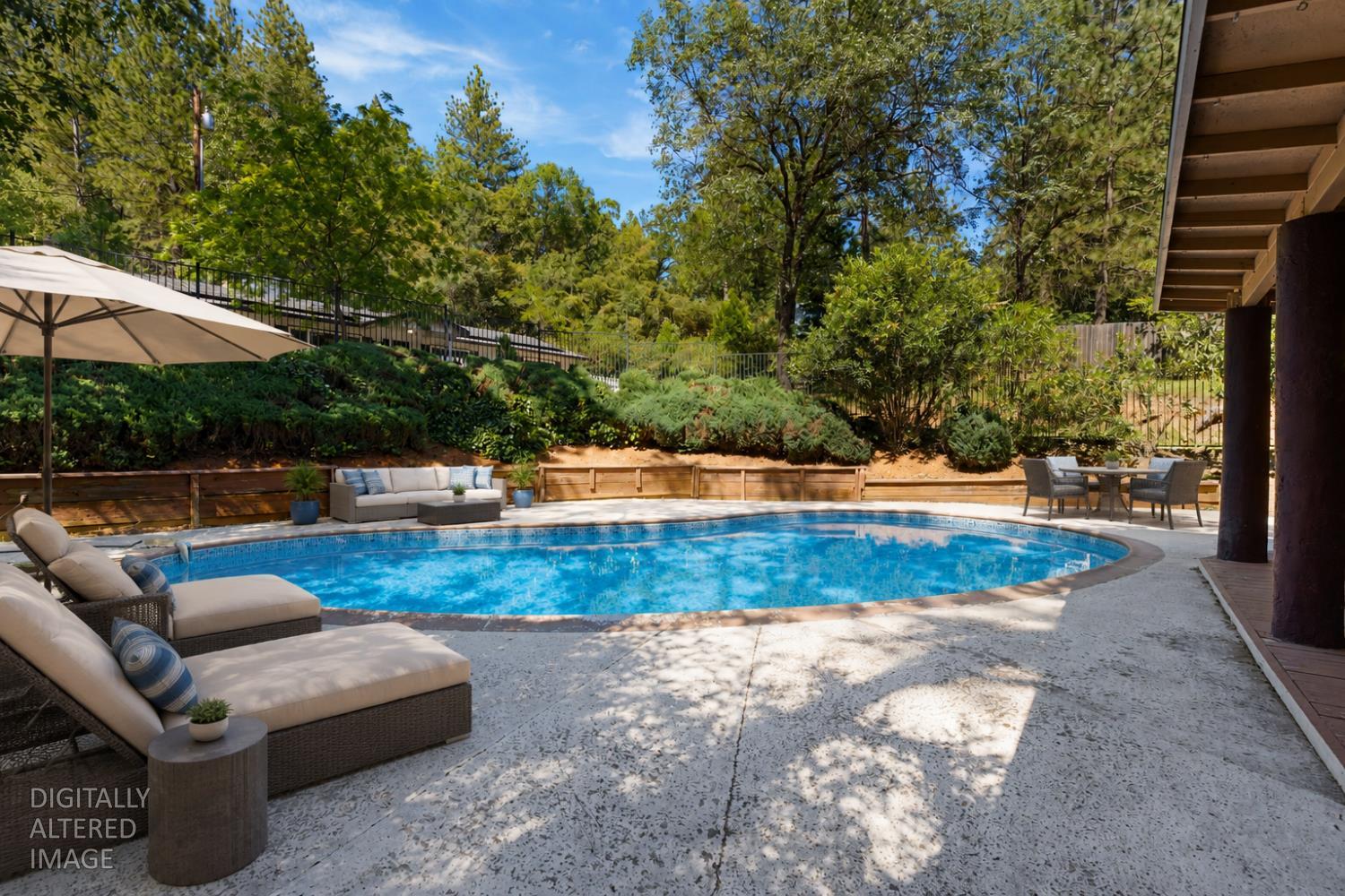 2971 Letitia Avenue Placerville, CA 95667 - Photo 15 of 65 a view of a backyard with lawn chairs under an umbrella