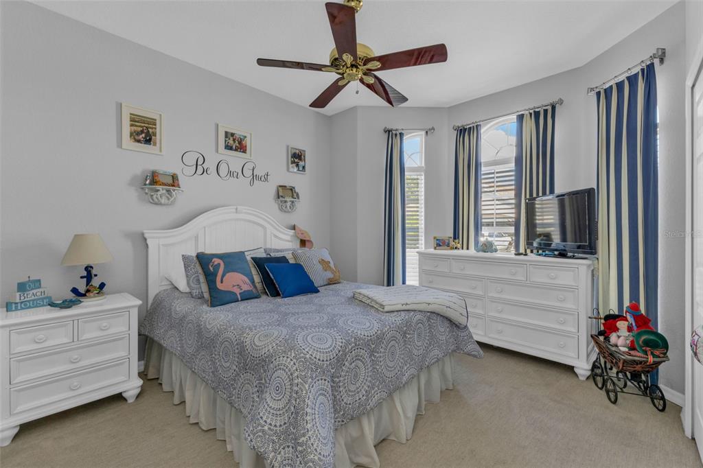 24439 Buckingham Way Punta Gorda, FL 33980 - Photo 17 of 42 a bedroom with a bed and a chandelier