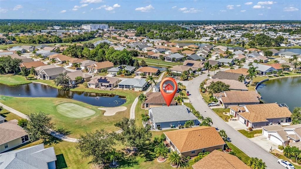 24439 Buckingham Way Punta Gorda, FL 33980 - Photo 22 of 42 an aerial view of a house with a swimming pool yard and outdoor seating