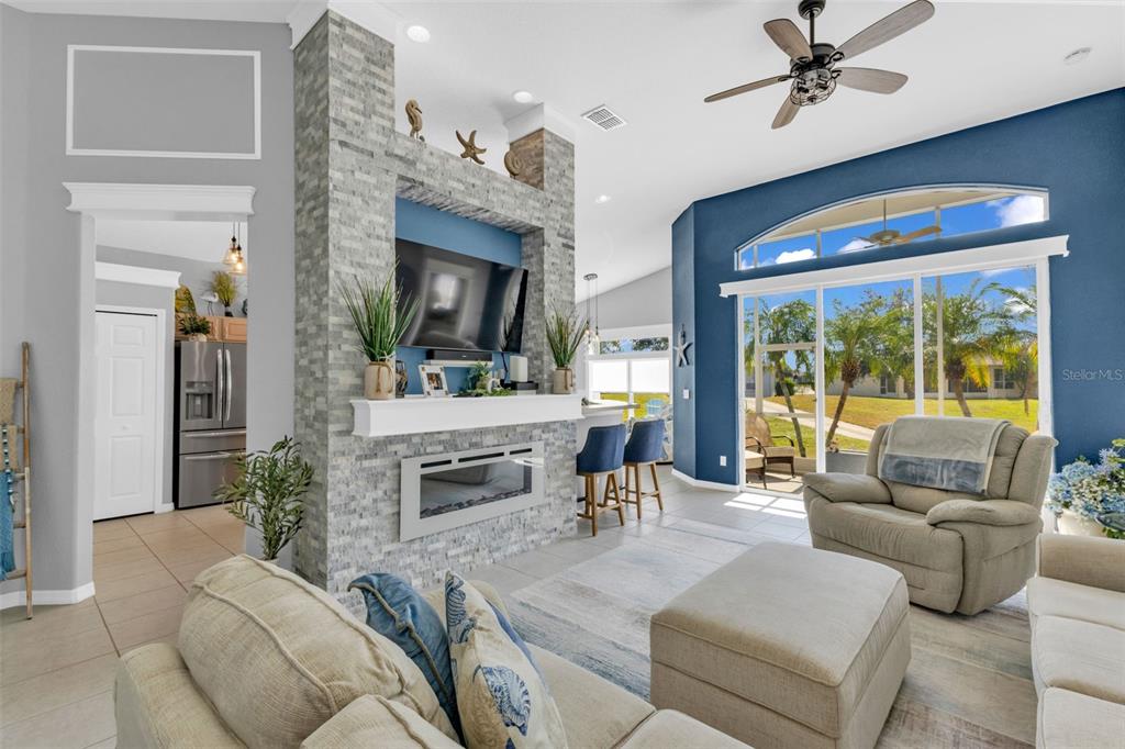 24439 Buckingham Way Punta Gorda, FL 33980 - Photo 5 of 42 a living room with furniture and a fireplace