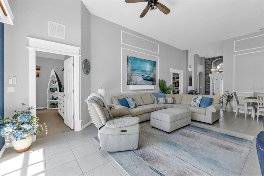 24439 Buckingham Way Punta Gorda, FL 33980 - Photo 6 of 42 a living room with furniture and a chandelier