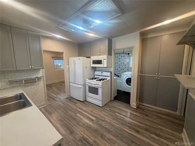 a kitchen with stainless steel appliances a refrigerator and a stove top oven