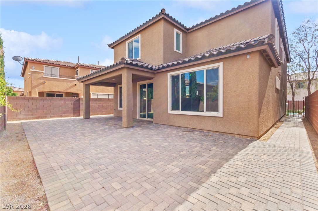 11048 Prairie Grove Road Las Vegas, NV 89179 - Photo 71 of 75 A spacious brick paver patio extends from a covered outdoor living area, perfect for alfresco enjoyment.