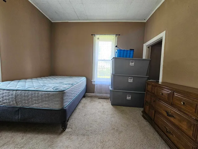 a bedroom with a bed and a closet