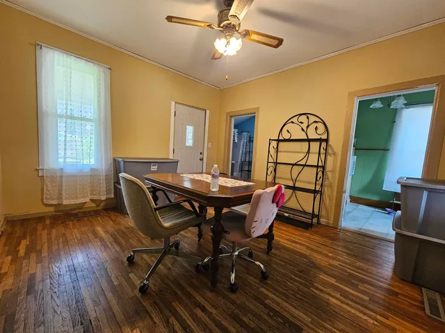a view of a dining room with furniture window and wooden floor