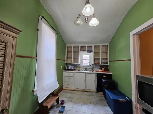 a kitchen with a sink cabinets and appliances