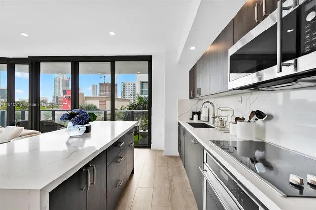 a kitchen with stainless steel appliances granite countertop a sink and stove