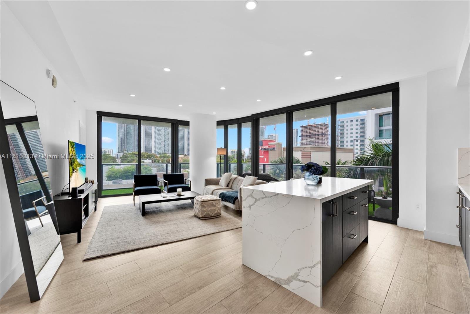 121 Northeast 34th Street, Unit L304 Miami, FL 33137 - Photo 12 of 36 a view of kitchen with a sink a counter top space and living room