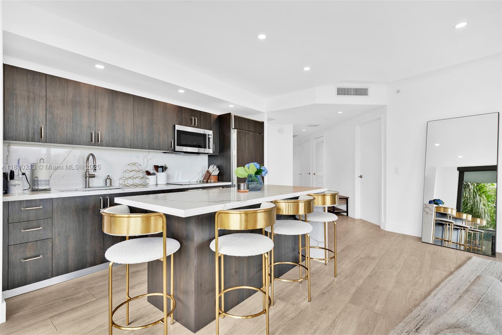 121 Northeast 34th Street, Unit L304 Miami, FL 33137 - Photo 13 of 36 a kitchen with stainless steel appliances a stove a sink and a refrigerator