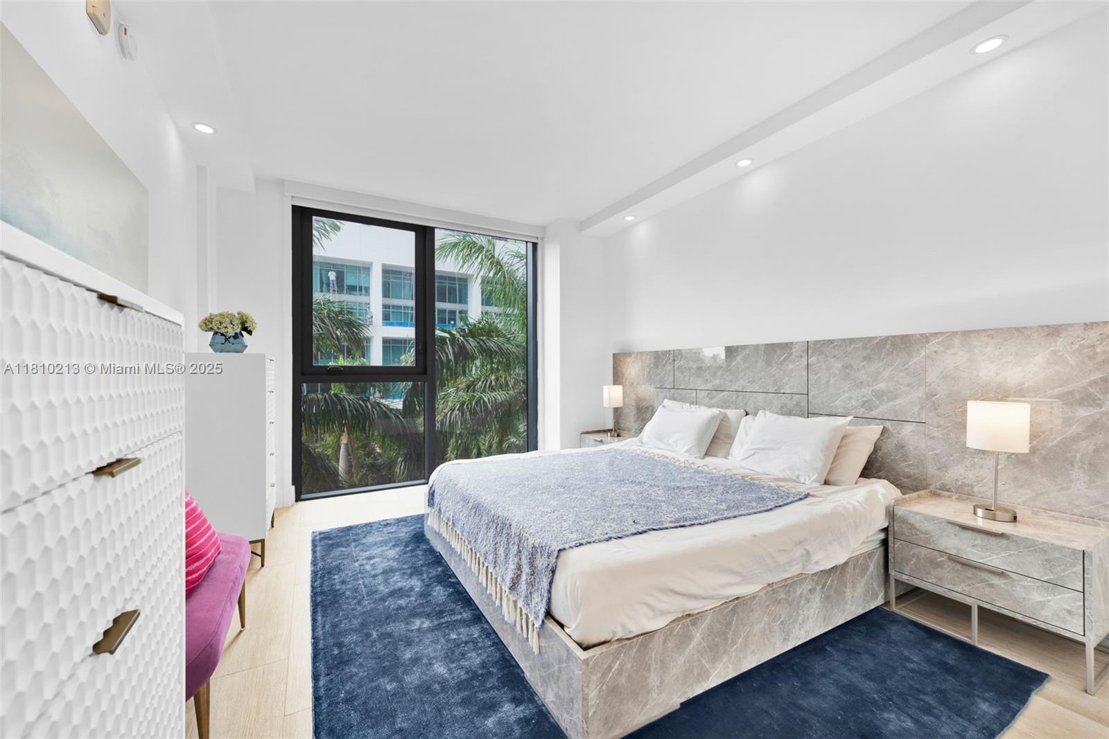 121 Northeast 34th Street, Unit L304 Miami, FL 33137 - Photo 16 of 36 a bed room with a bed and a large window