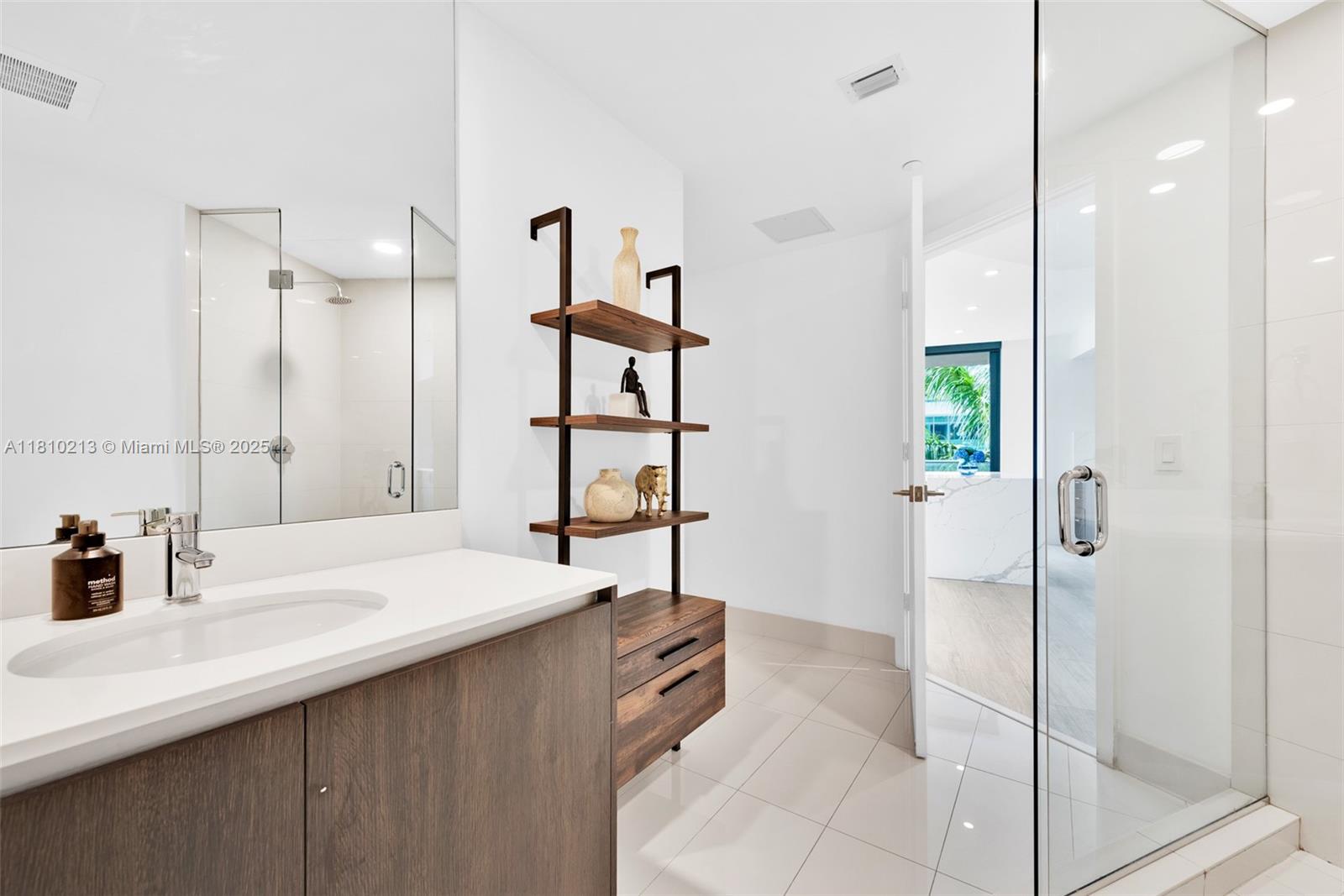 121 Northeast 34th Street, Unit L304 Miami, FL 33137 - Photo 25 of 36 a bathroom with a sink and a mirror