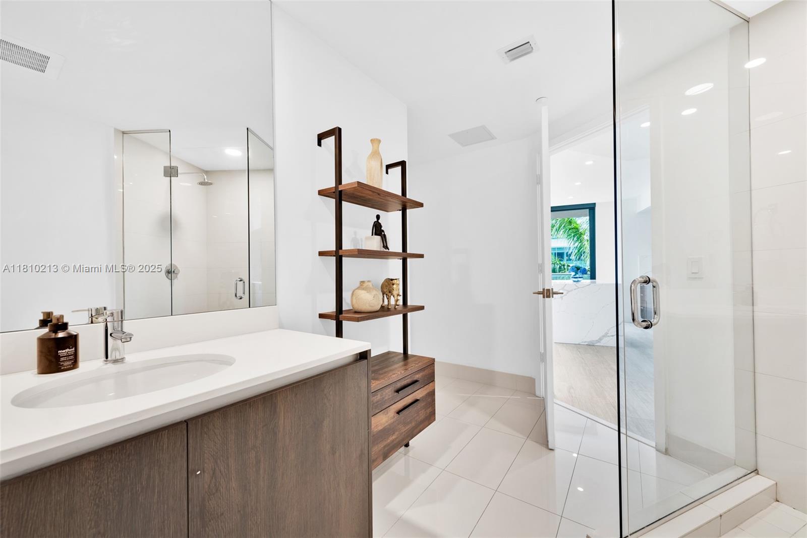 121 Northeast 34th Street, Unit L304 Miami, FL 33137 - Photo 26 of 36 a bathroom with a sink and a shower