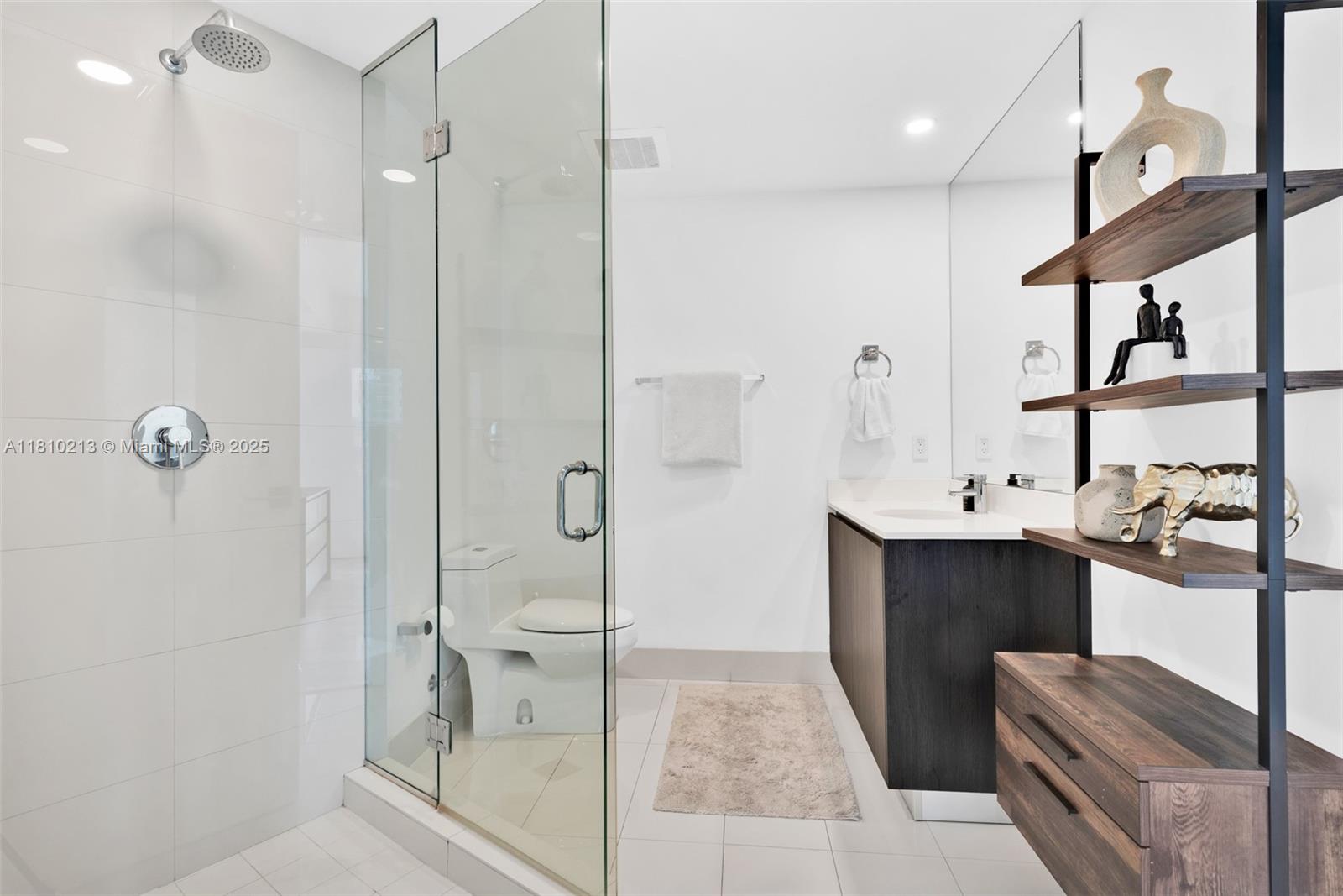 121 Northeast 34th Street, Unit L304 Miami, FL 33137 - Photo 27 of 36 a bathroom with a sink and a shower