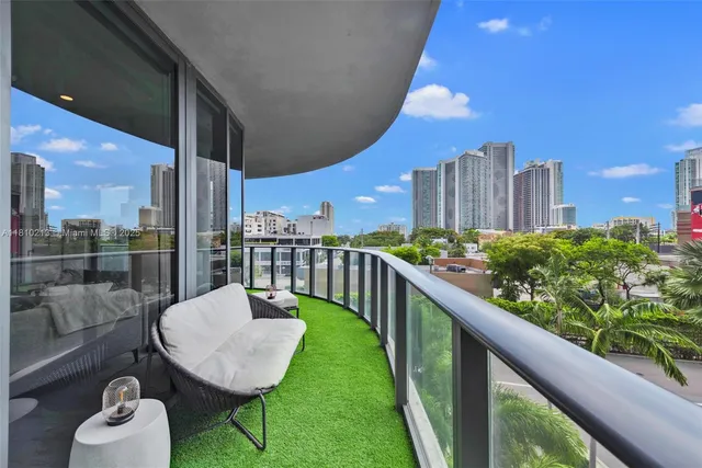 a balcony view with a seating space