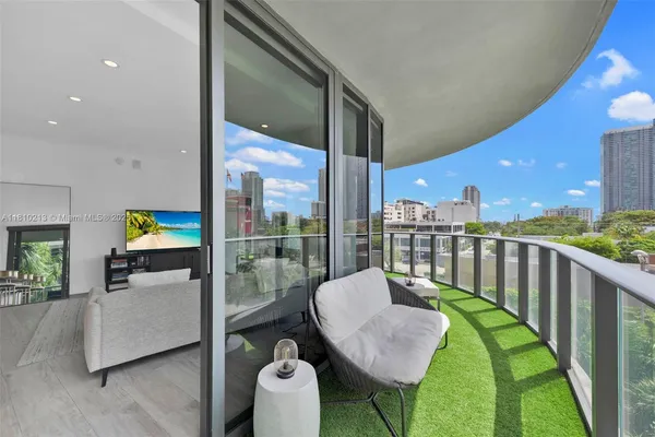 a balcony with table and chairs