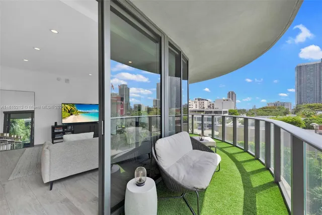 a balcony with table and chairs