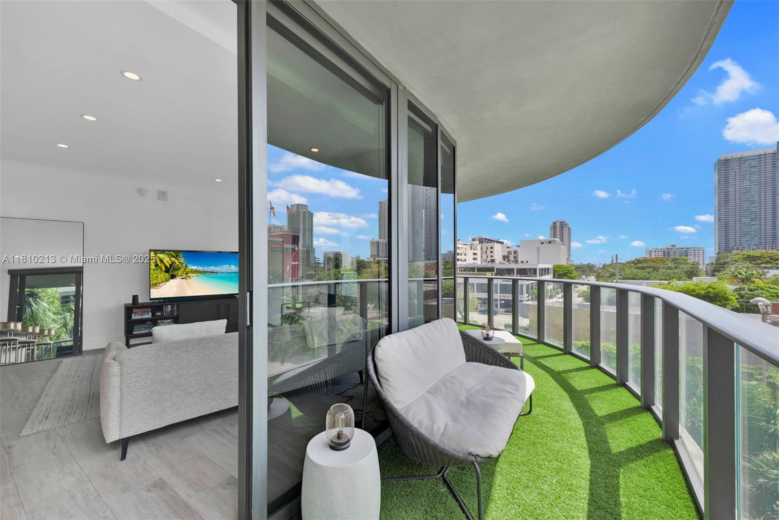 121 Northeast 34th Street, Unit L304 Miami, FL 33137 - Photo 32 of 36 a balcony with table and chairs