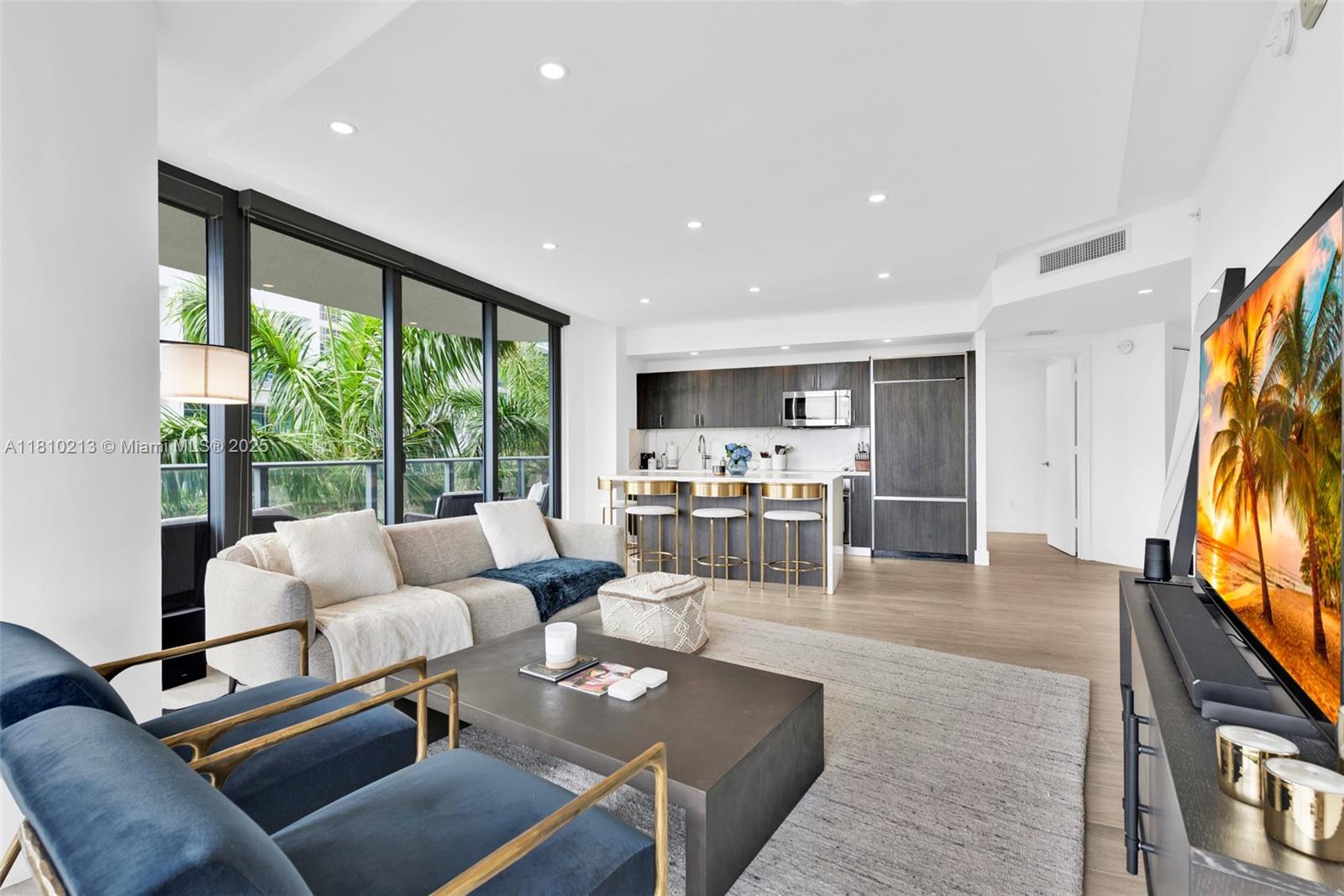 121 Northeast 34th Street, Unit L304 Miami, FL 33137 - Photo 7 of 36 a living room with furniture fireplace and flat screen tv