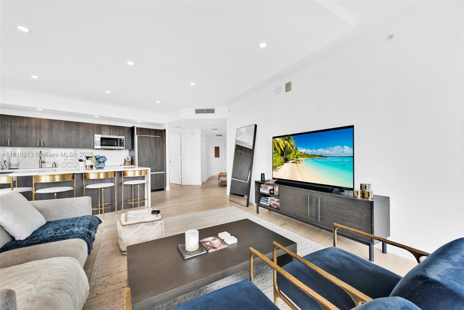 121 Northeast 34th Street, Unit L304 Miami, FL 33137 - Photo 8 of 36 a living room with furniture and a flat screen tv